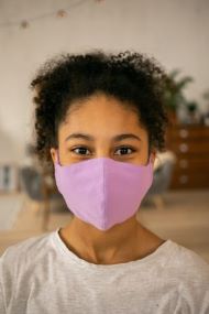 Young black woman masked to protect against COVID-19